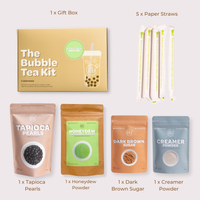 Bubble Tea Kit with packaging, tapioca pearls, honeydew powder, dark brown sugar, creamer powder, and straws on a light background.